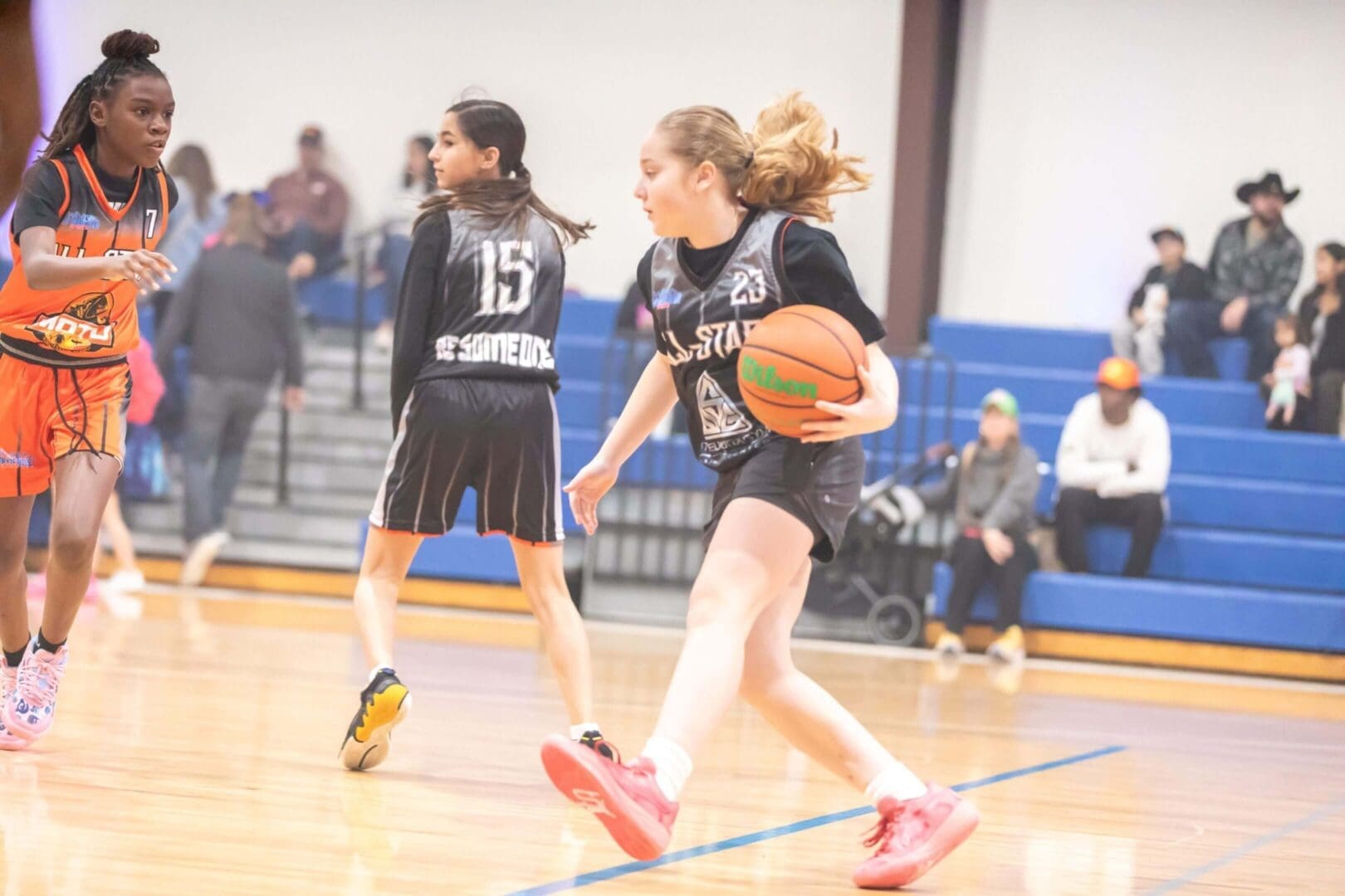 Girls playing basketball in a gymnasium