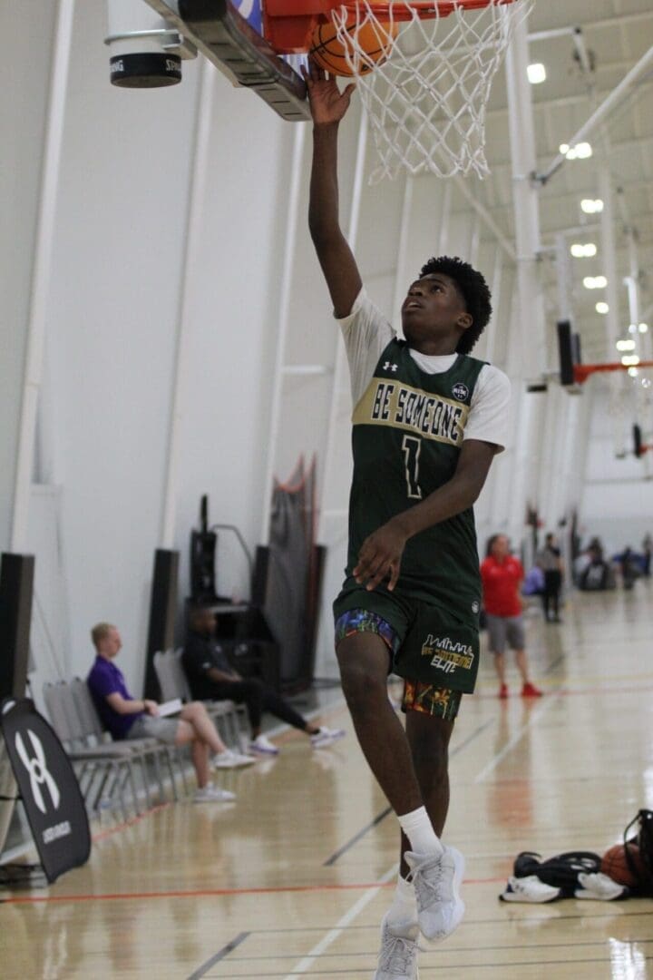 Basketball player performing a layup indoors.