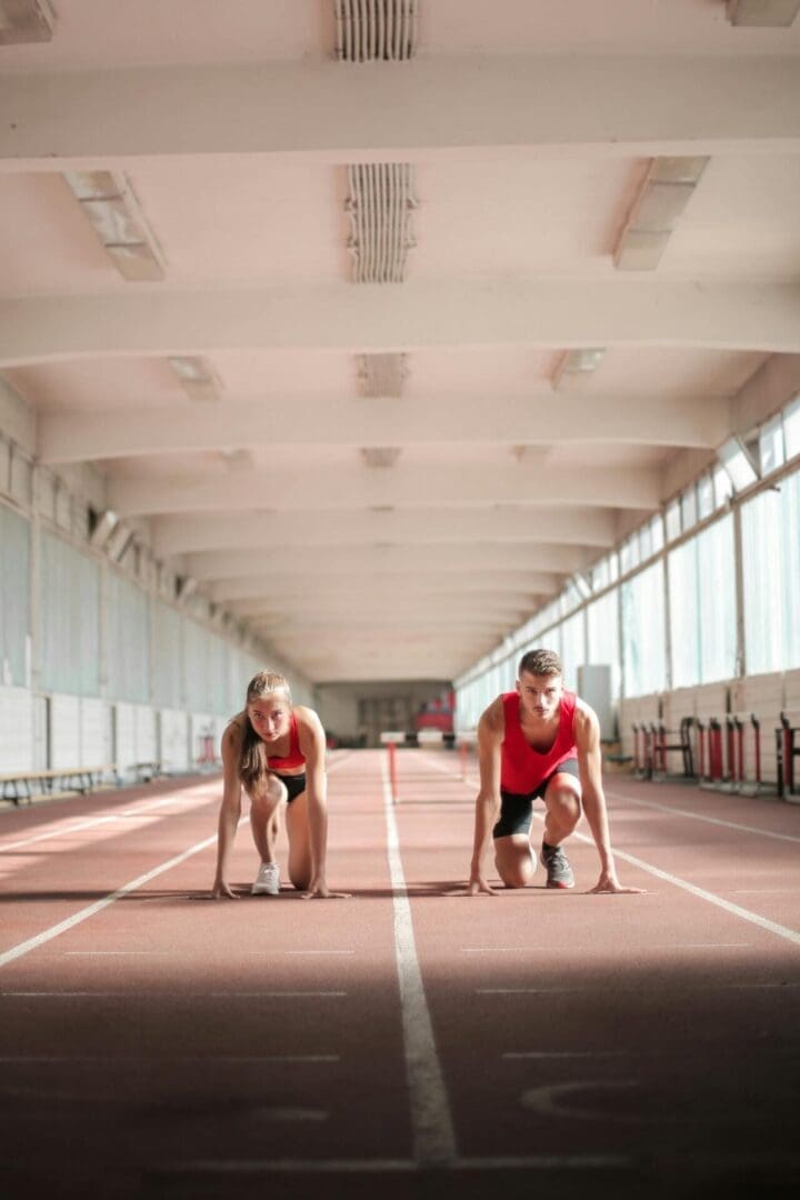 Young athletes lacing up sneakers and preparing for training