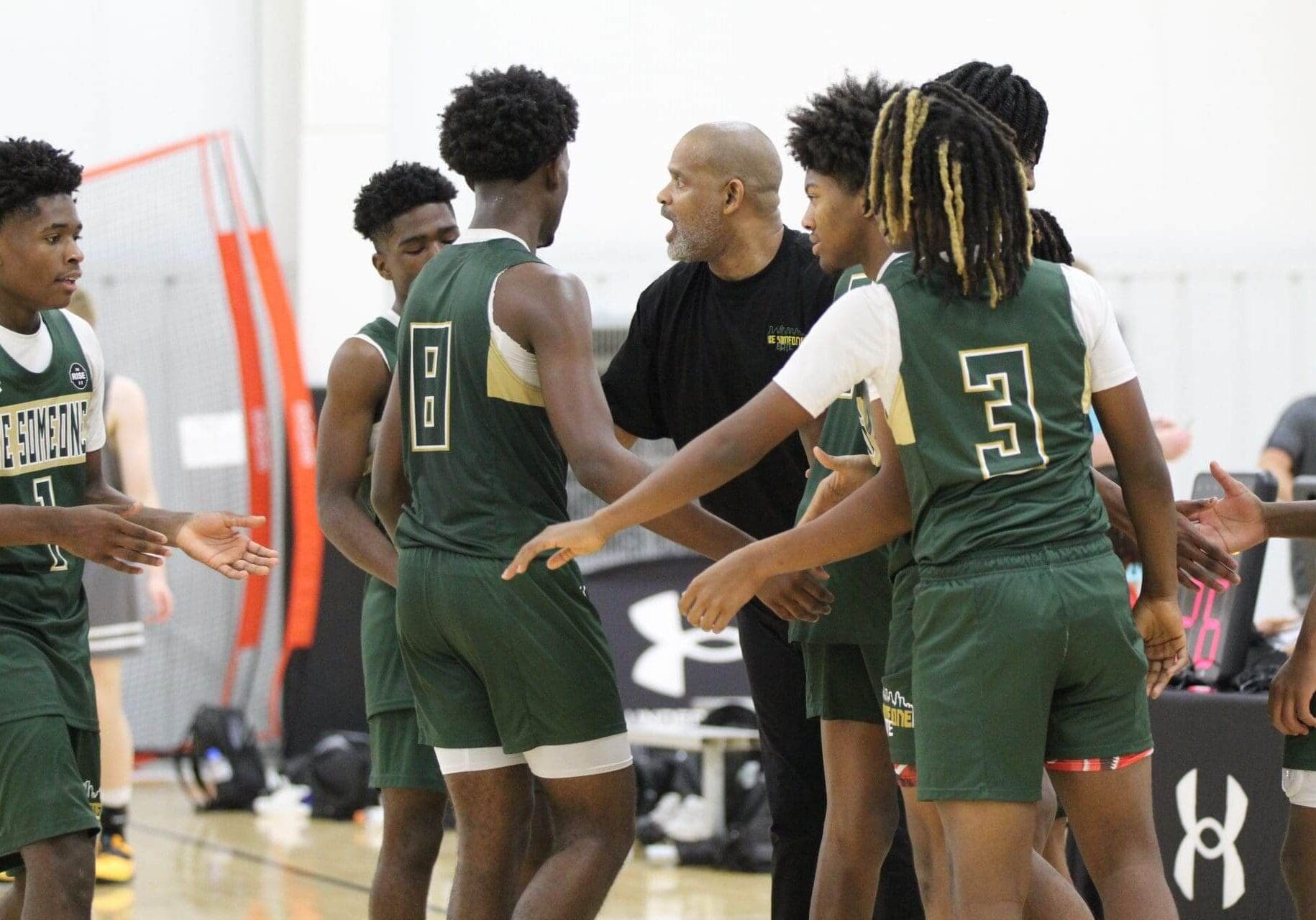 Basketball team huddles during a game.